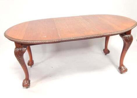 An oval mahogany extending dining table