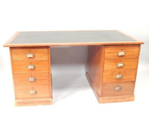 A 1930s oak twin pedestal desk