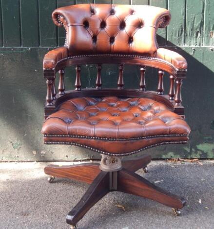 A leather button back captains office chair