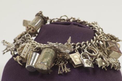 A silver and white metal charm bracelet