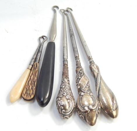 A collection of silver handled button hooks