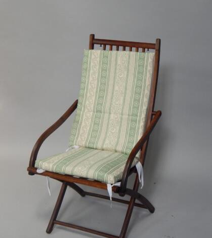 An Edwardian beech and walnut folding deck chair.