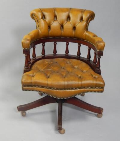 A leather seated button back captain's chair