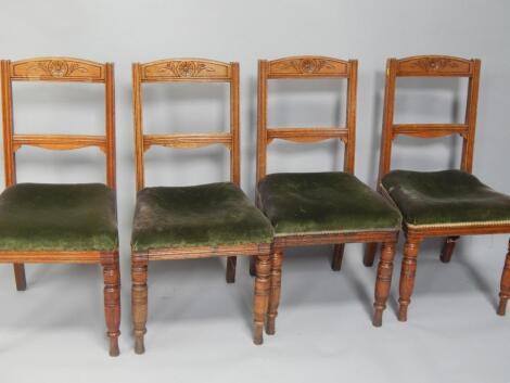 A set of four early 20thC upholstered seat oak dining chairs.