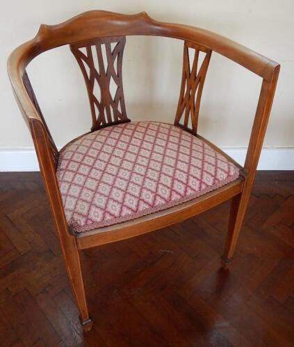 An Edwardian inlaid mahogany open armed tub chair