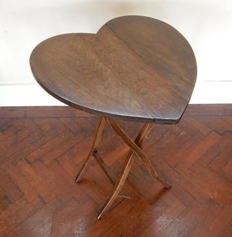 A stained beech heart shaped coaching style folding table.
