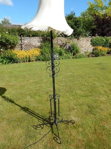 A wrought iron standard lamp