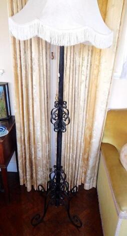 A wrought iron standard lamp