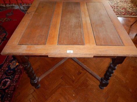 An oak draw-leaf dining table