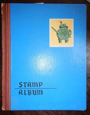 A stock book and a collection of used stamps.