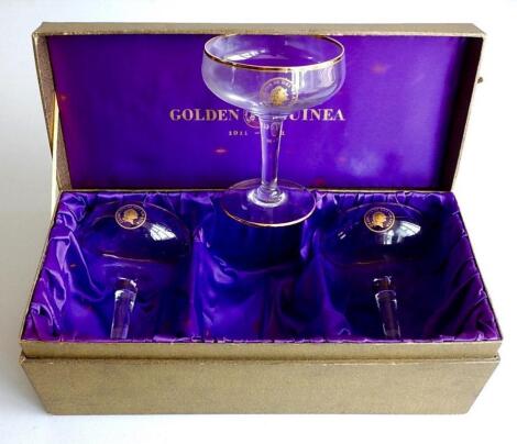 Three Golden Guinea champagne glasses