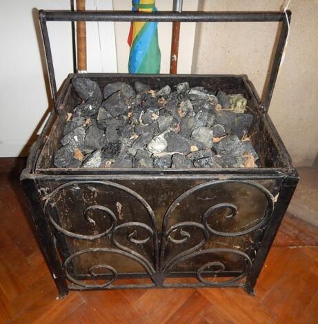 A wrought iron and steel coal box with swing handle.