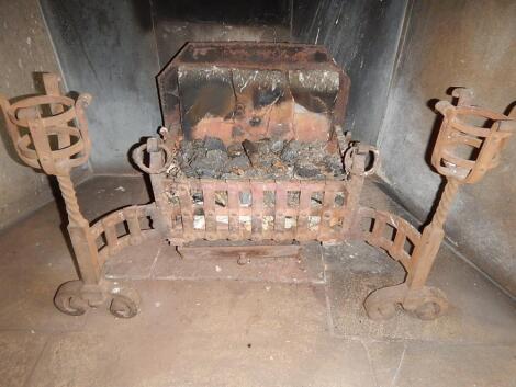 A heavy cast iron fire basket on scroll supports.