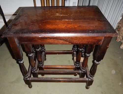 A nest of three oak tables.