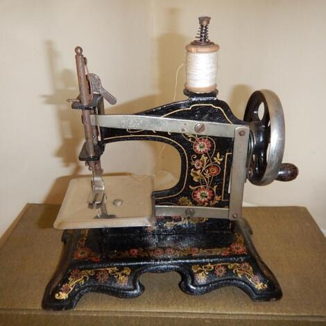 An early 20thC German tin plate childs sewing machine