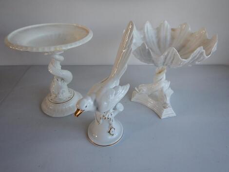 Two white porcelain table centres with dolphin stems