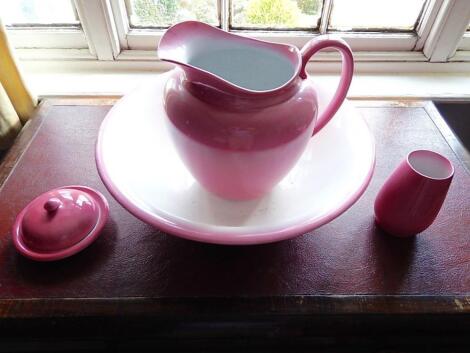 A pink toilet jug and bowl set.
