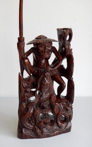 A Chinese carved hardwood figure of a fisherman