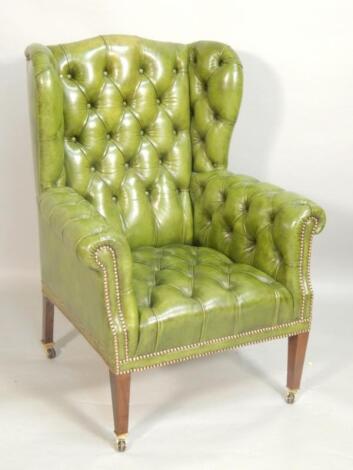 A late 19th/early 20thC mahogany wing back armchair