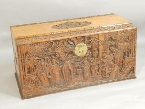 A mid 20thC extensively carved Chinese camphorwood chest