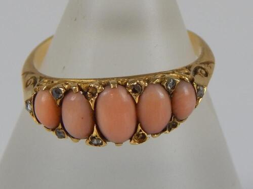 An 18ct gold coral and diamond gypsy ring