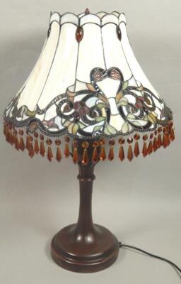 A modern Tiffany type stained glass and bronzed table lamp