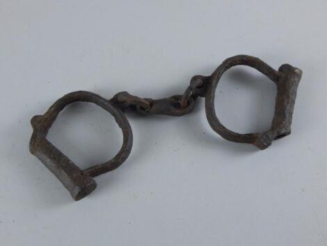 A pair of iron child's hand cuffs