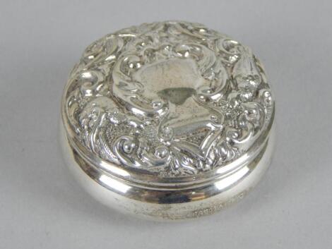 A modern embossed silver circular box and cover