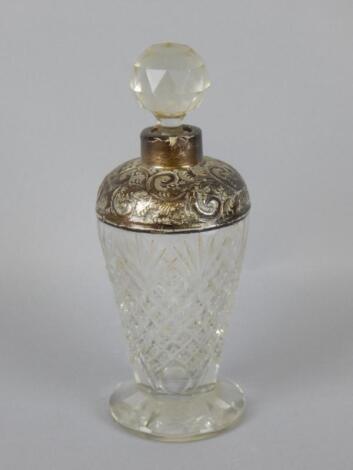 A cut glass scent bottle and stopper