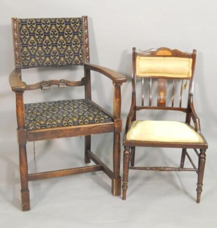 An early 20thC carved oak open armchair