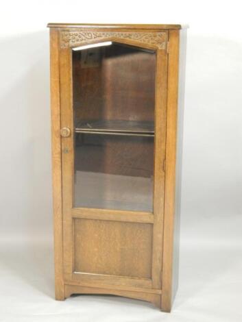 A mid 20thC oak display cabinet