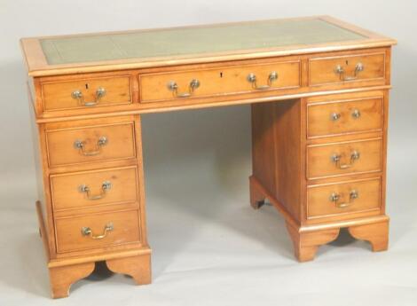 A reproduction yew pedestal desk