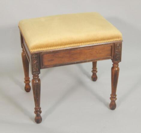 An Edwardian walnut piano stool