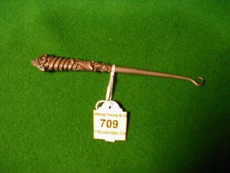 A Victorian silver button hook with rococo scrolling handle