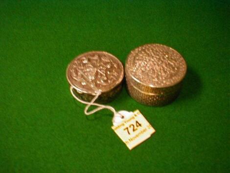 Two circular continental white metal pill boxes