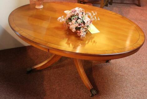 *A yew finish oval coffee table