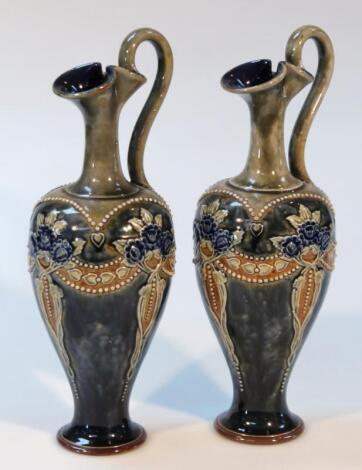 A pair of early 20thC Royal Doulton stoneware ewers