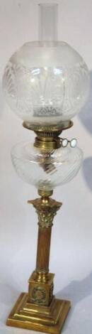 An Edwardian brass frosted and clear glass oil lamp