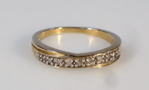 A ladies' stone set cross over ring