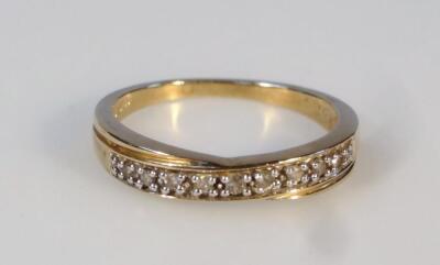 A ladies' stone set cross over ring