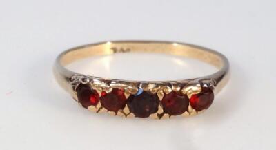 A ladies' garnet five stone dress ring