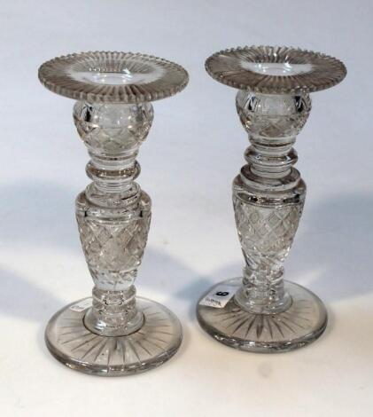 A pair of 19thC cut glass candlesticks