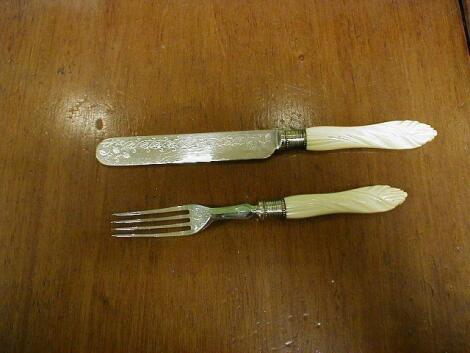 A set of 12 ivory handled dessert knives and forks