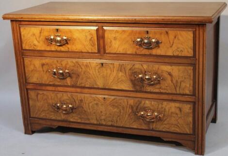 An Edwardian walnut veneered low chest