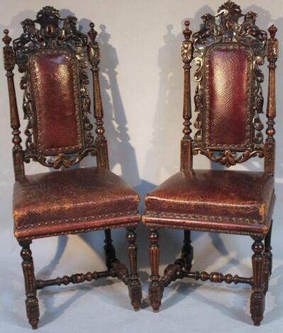 A near matching pair of 19thC oak Carolean style hall chairs