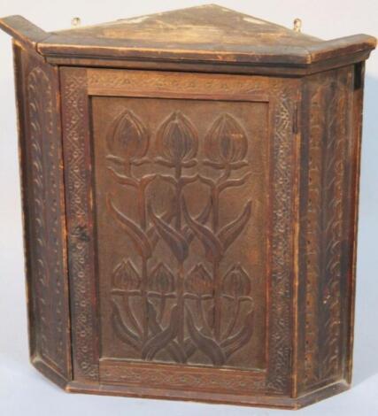 A late 19thC/early 20thC oak Arts and Crafts hanging corner cupboard