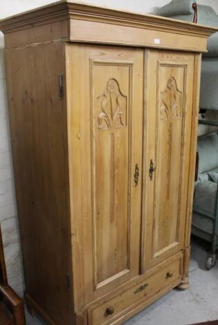 A stripped and lightly polished reconstituted pine double drawer armoire