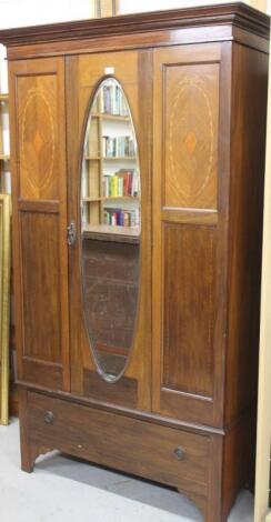 An Edwardian mahogany and boxwood strung single door wardrobe