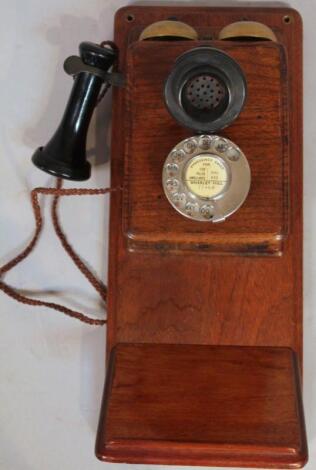 An early 20thC oak cased wall telephone