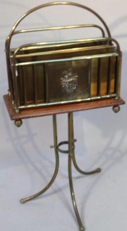 An Edwardian mahogany and brass newspaper rack